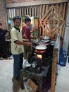 Photo editorial, 27 november 2022, yogyakarta, indonesia, mie godog maker and seller, using charcoal