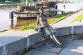 Novgorod, Russia - August 31, 2018: Sculpture of tired tourist girl on the background of the river. Girl-Tourist Monument