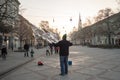 NOVI SAD, SERBIA - DECEMBER 13, 2015: Street performer making soap bubbles in order to amuse people passing by pn Novi Sad main st Royalty Free Stock Photo