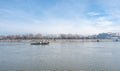 Small tugboat or towboat sail on the Danube river with clear blue sky above.