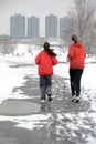 Two girls jogging in snow Royalty Free Stock Photo