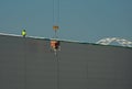 NOVI SAD, SERBIA - July 14th: Worker supervising crane lifting weight