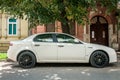 White Alfa Romeo 159 car with black alloy wheels parked on the street. Royalty Free Stock Photo