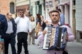 Accordionist with his accordion standing in front Roma band playing music during a wedding in the capital city of the Serbian Aut