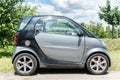 Small black and grey Smart car parked on the street Royalty Free Stock Photo