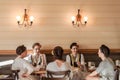 NOVI SAD, SERBIA - JUNE 11, 2017: Young women wearing a traditional Serbian costume having a drink in a local cafe Royalty Free Stock Photo