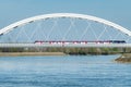 Novi Sad, Serbia - March 24, 2023: High-speed train Soko on Zezelj bridge over Danube bridge. This train travels between Belgrade