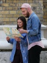 Two young traveling couple tourists with map in a city finding the location