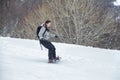 Novice girl is learning to ski with snowboard