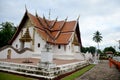 Novice monk use sweep cleaning front of Ubosot t Wat Phu Mintr o