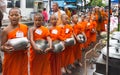 Novice monks collecting alms on the market in old Phuket town, Thailand