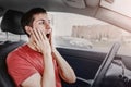 Newbie driver was confused and let go hands of the steering wheel of the car. He screams and doesn`t control his emotions.