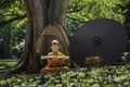 Novice sitting reading the courtyard under the tree Royalty Free Stock Photo