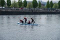 Novice students learn stand up paddle boarding at Salford Quays in Manchester, UK