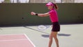 Novice tennis player doing an underhand serve