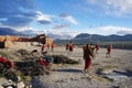 Novices gompa playing volleyball during the holiday, in the back of the monastery, on the background of the Himalayas.