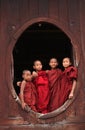 Novices standing at the wooden monastery in Shan, Myanmar