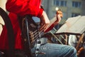 Novokuzneck, Russia - 13.08.2017: the bass guitarist plays in an orchestra on the street