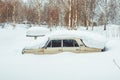 Novokuzneck, Russia - 24.02.2018: the old car is littered with snow
