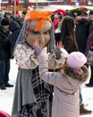 Holiday farewell to winter. A big doll plays with the girl on holiday.