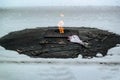 Novokuznetsk,Russia-21.03.2021.a bouquet of flowers lies on the eternal flame in winter-a monument to the fallen soldiers in the