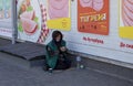 Novomoskovsk, Ukraine - May 13, 2021: Beggar woman on street asking for money. Beggars. Social problem. Social