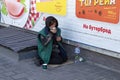 Novomoskovsk, Ukraine - May 13, 2021: Beggar woman on street asking for money. Beggars. Social problem. Social