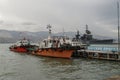 Close-up view of pilot boats moored at the pier and the museum cruiser "Mikhail Kutuzov" in the background.