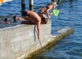 Children catch a net of small fishes in sea water Royalty Free Stock Photo