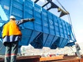 Raising the hopper car for unloading on a cargo ship. Lifting operations in the port.