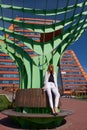 Modern young woman on the steps of Building of Information Technology Center in Akademgorodok. The symbol of Novosibirsk