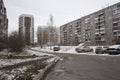 Asphalt road leads between apartment buildings with parked cars in a typical residential area of Ã¢â¬â¹Ã¢â¬â¹Novosibirsk in winter.
