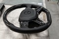 Novosibirsk, Russia - 08.01.2018: Carbon steering wheel of a black car in the workshop tightened and perforated with natural