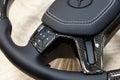 Novosibirsk, Russia - 08.01.2018: Carbon steering wheel of a black car in the workshop tightened and perforated with natural
