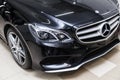 Close-up on a car Mercedes E-class body standing inthe garage box for polishing and removing scratches from the surface. Auto