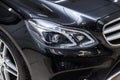 Close-up on a car Mercedes E-class body standing inthe garage box for polishing and removing scratches from the surface. Auto