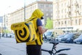 Novosibirsk, Russia-30.04.2020: a fast food delivery courier dressed in a yellow uniform delivers it on a bicycle