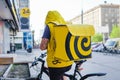 Novosibirsk, Russia-30.04.2020: a fast food delivery courier dressed in a yellow uniform delivers it on a bicycle