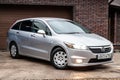 Front view of a Honda Stream car in a silver body Japanese 2008 year van in a parking Royalty Free Stock Photo