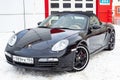 Front view of the 2006 sports porsche boxster s coupe roadster prepared for sale with a polished shiny black body on snow winter