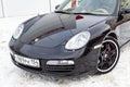 Front view of the 2006 sports porsche boxster s coupe roadster prepared for sale with a polished shiny black body on snow winter