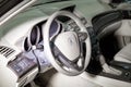 The interior of the car Acura MDX with a view of the steering wheel, dashboard, seats and multimedia system with light gray