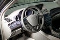 The interior of the car Acura MDX with a view of the steering wheel, dashboard, seats and multimedia system with light gray