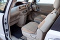 The interior of the car Toyota Porte in the back of a minivan with a wide open door and a view of the control panel, steering Royalty Free Stock Photo