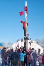 Boy climbing on a wooden pole for the prize, Slavonic folk festivities Shrovetide or Maslenitsa