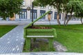 Novosibirsk, Russia - July 7, 2021: Green grand piano with flower box at the Opera and Ballet Theater in Novosibirsk