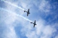 Mochishche airfield, local air show, two Yak-52, aerobatic team `Open Sky`, Barnaul, on blue sky with clouds background