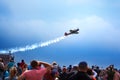 Mochishche airfield, local air show, yak 52 on blue sky with clouds background and many viewers, people watch aviashow