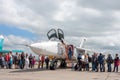 Civilians stand in line to get into the cockpit of a military aircraft