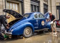 NOVOSIBIRSK, RUSSIA - JUNE 25, 2016: Two drivers wash a retro car at a stopover in Siberia Royalty Free Stock Photo